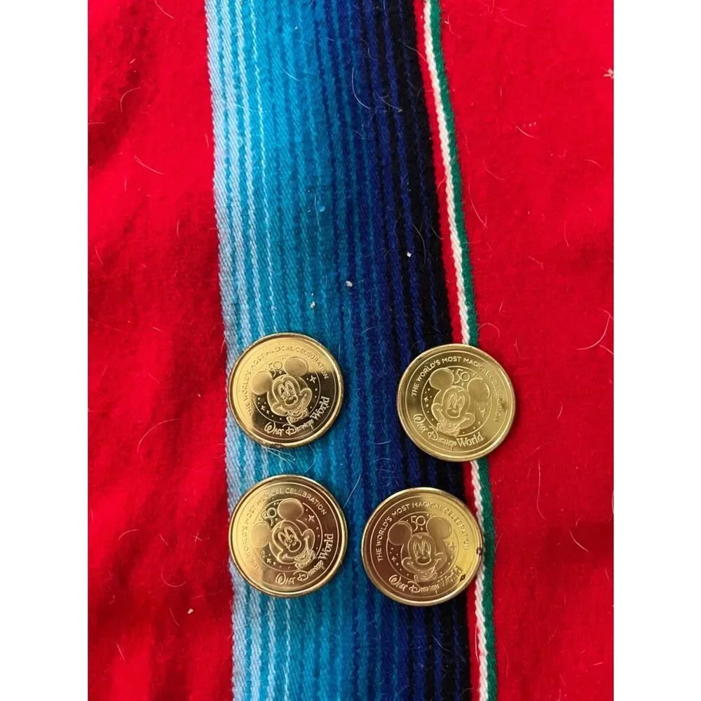 Disney Gold-Tone Collectible Coins on Red and Blue Stripe Fabric